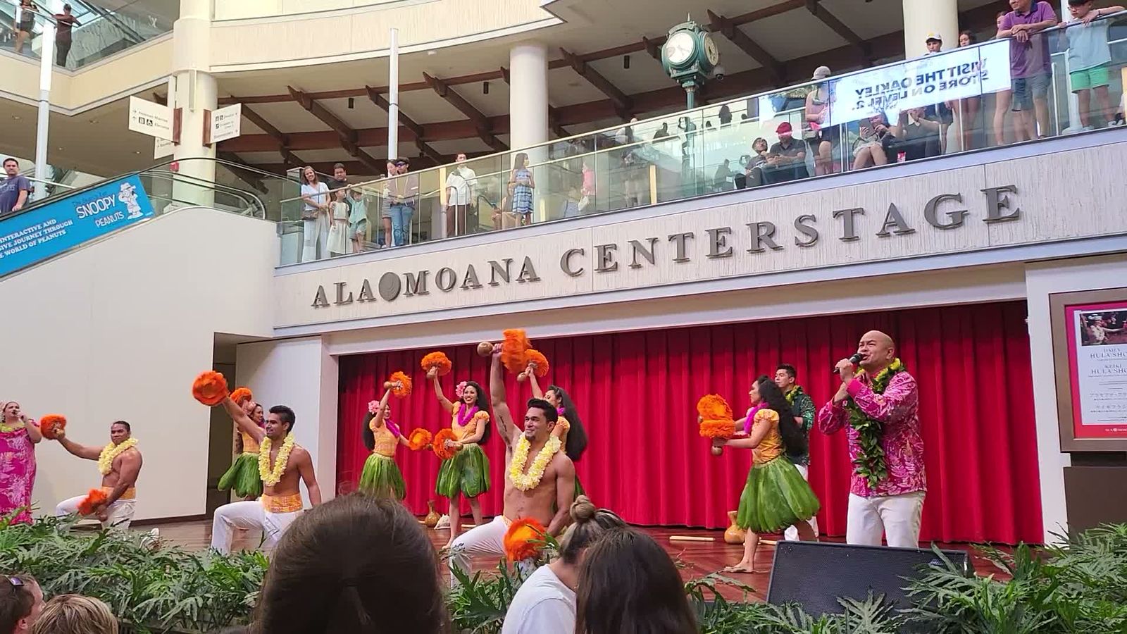Hula dancers performing with 'uli'uli gourd rattles at Ala Moana Centerstage