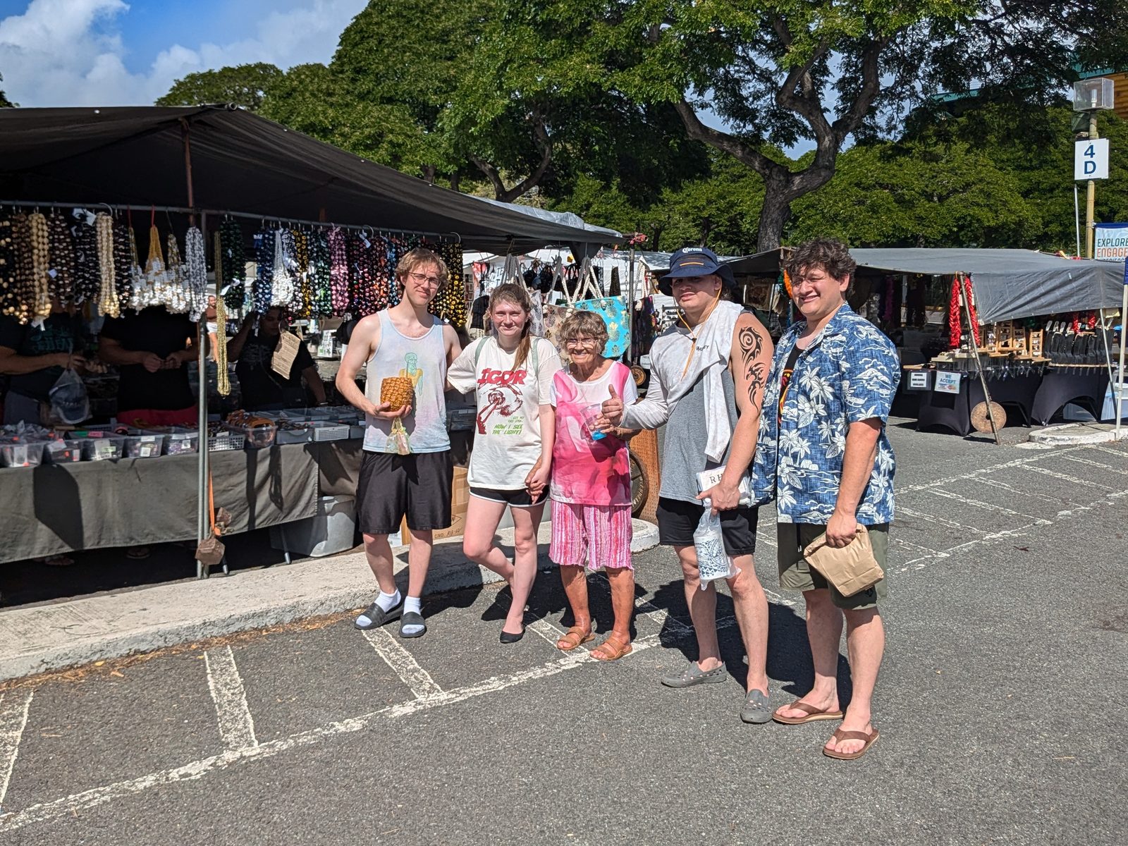 Family standing among the vendor stalls at the Aloha Stadium Swap Meet, November 2024