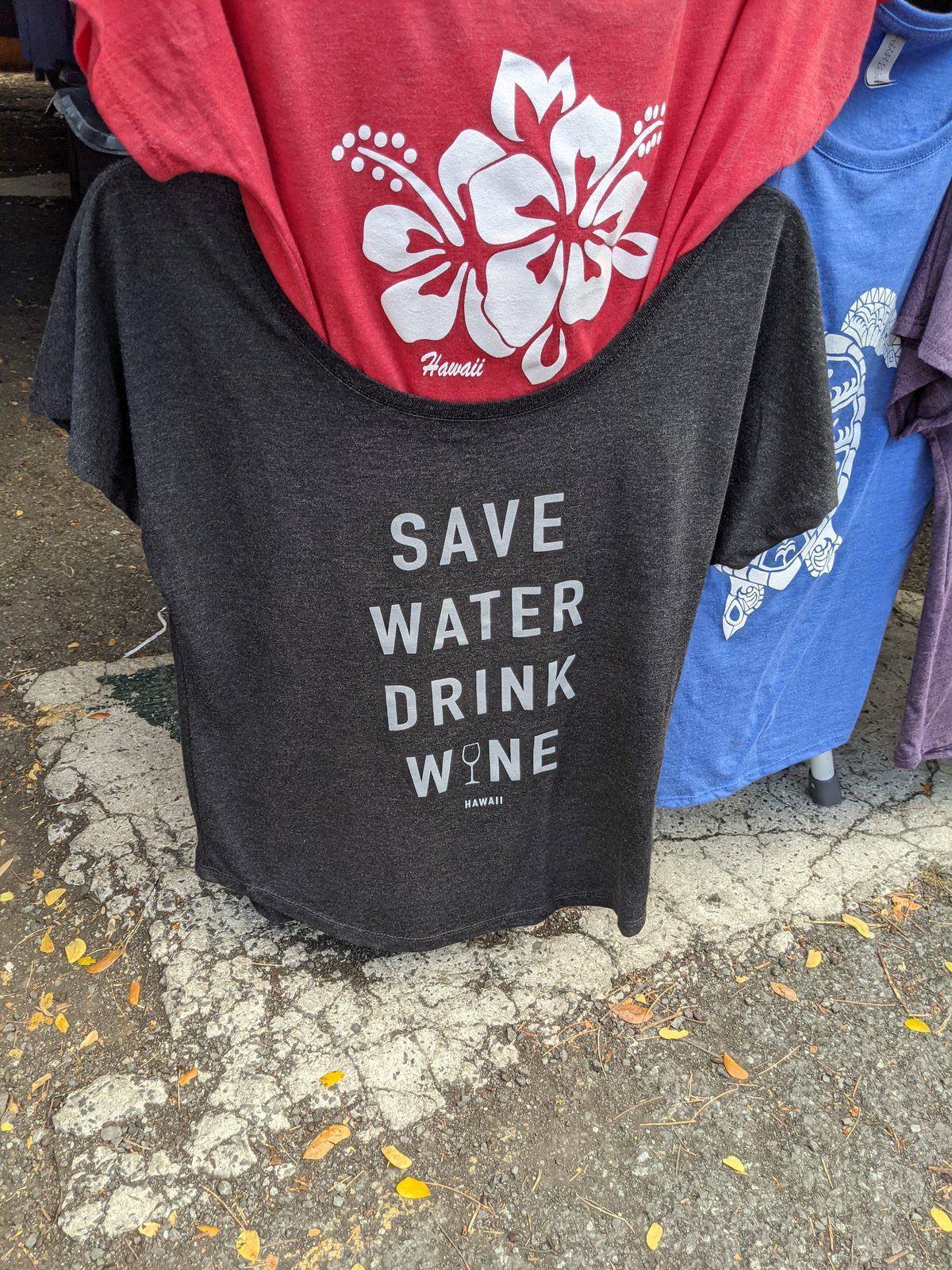 Hawaii souvenir T-shirts hanging at an Aloha Stadium Swap Meet stall, May 2021
