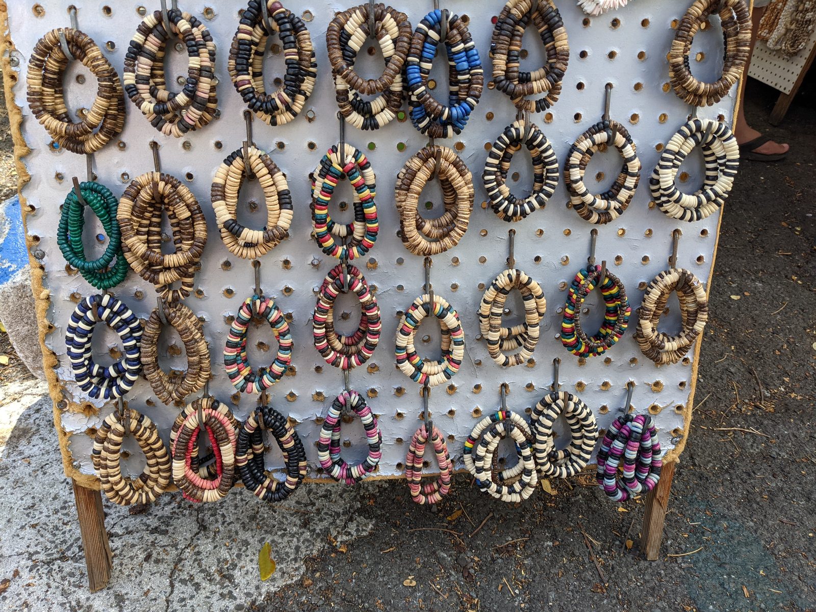 Beaded shell wreaths on a vendor's pegboard at the Aloha Stadium Swap Meet, May 2021