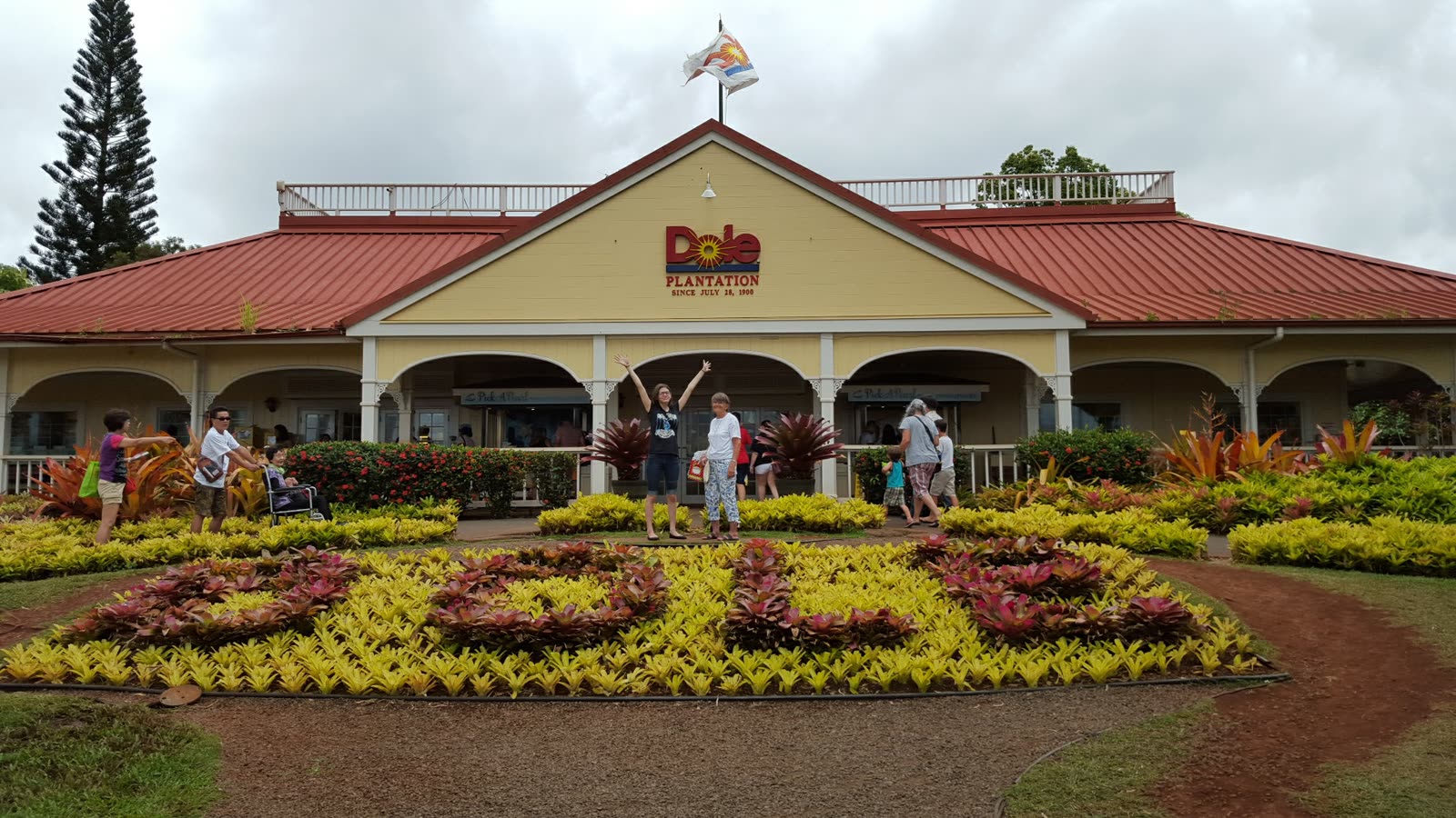 Dole Plantation main building with flower beds, June 2017