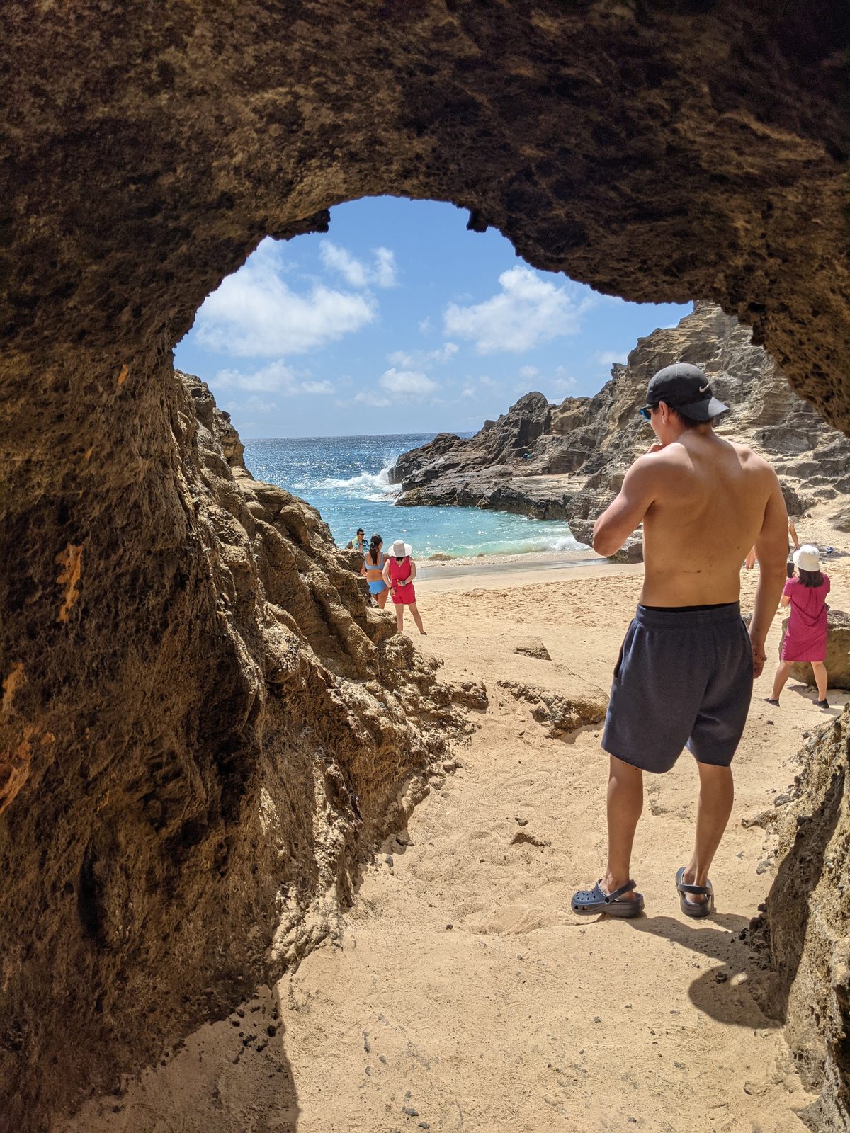 Walking through the lava tube opening onto Halona Cove beach, May 2021