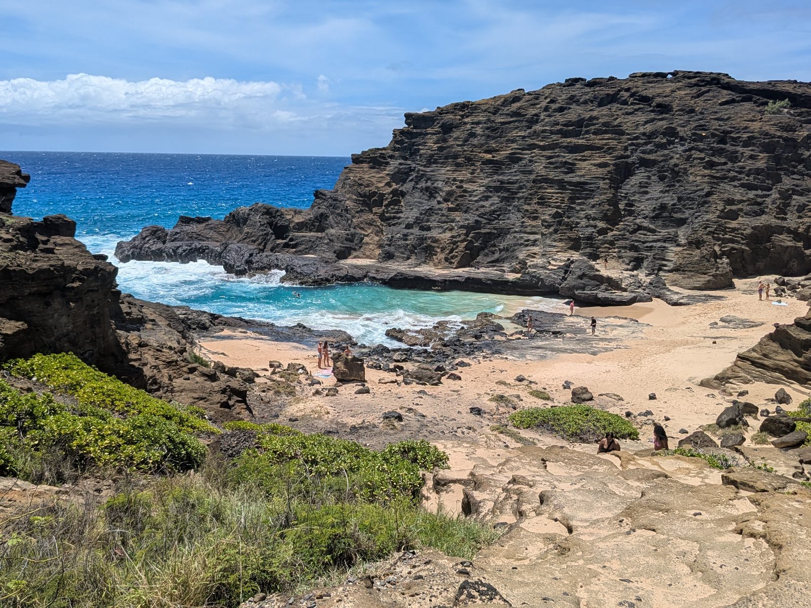 Surf rolling into Halona Cove, seen from above the cove