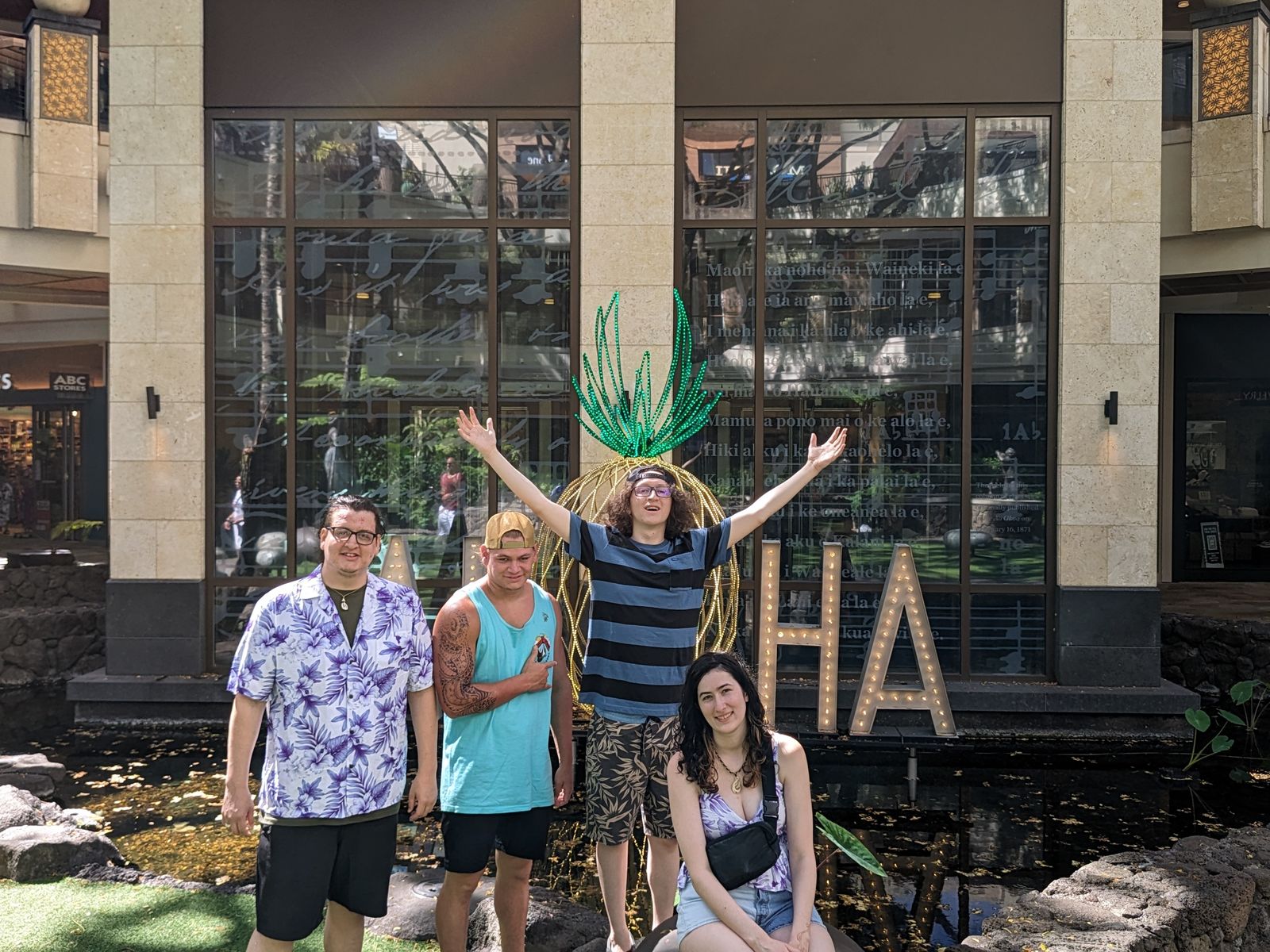 Visitors posing at the ALOHA pineapple sign at International Market Place, May 2024