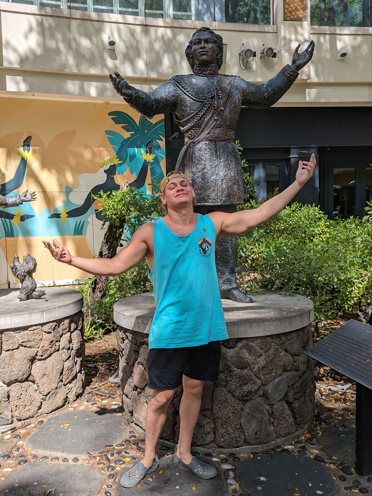 Michael striking the same pose as the statue at International Market Place, May 2024