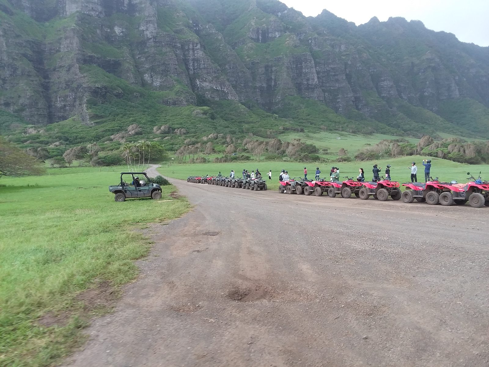 ATVs lined up for a tour beneath the Ko‘olau cliffs at Kualoa Ranch