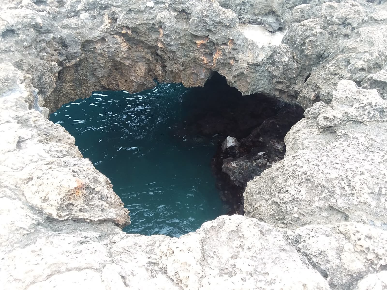 Mermaid Caves opening seen from above with turquoise water, March 2018