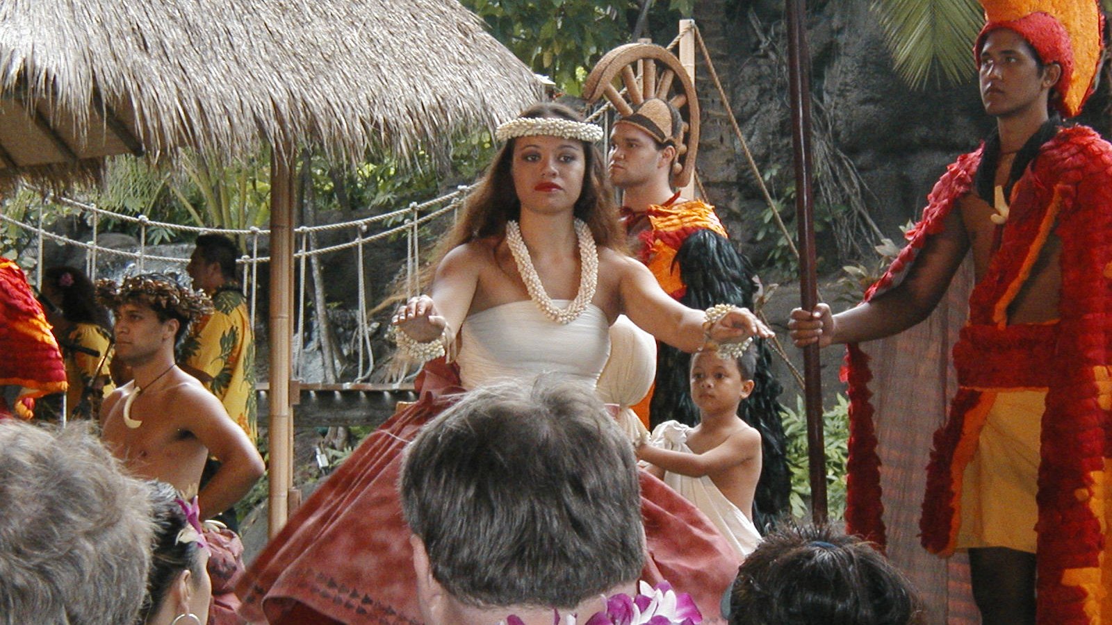 Performers in Hawaiian royal court dress at a Polynesian Cultural Center village
