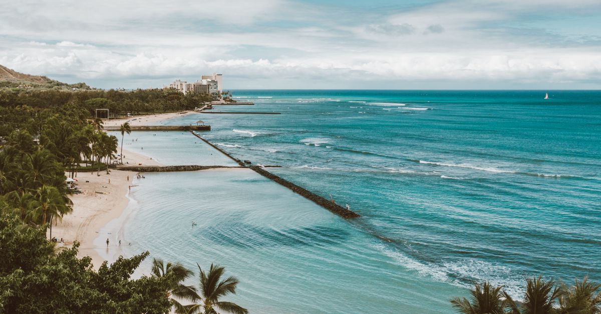 Aerial view of blue ocean and tropical coastline