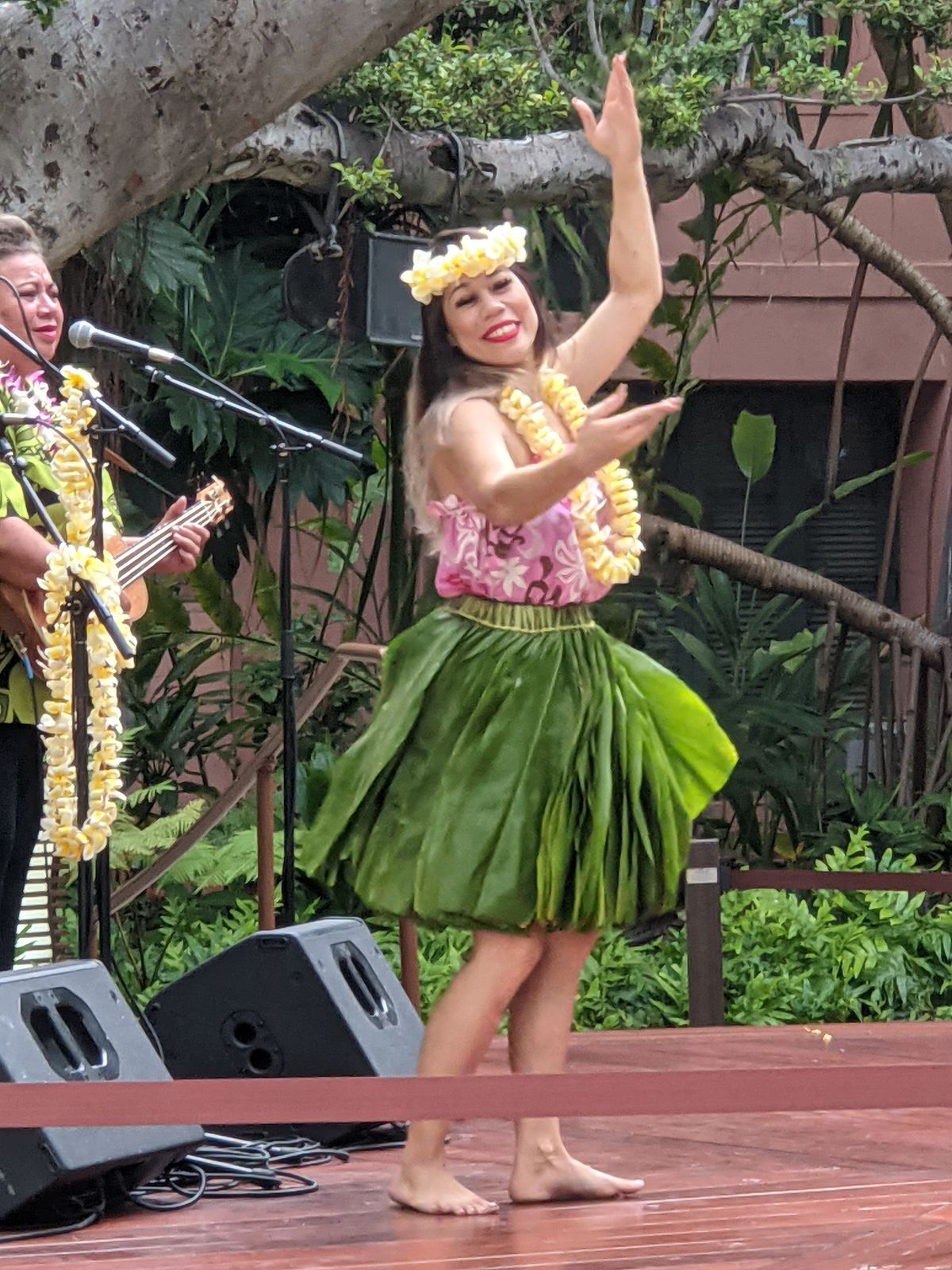 A hula dancer and musician performing at the Royal Grove, Royal Hawaiian Center, June 2021