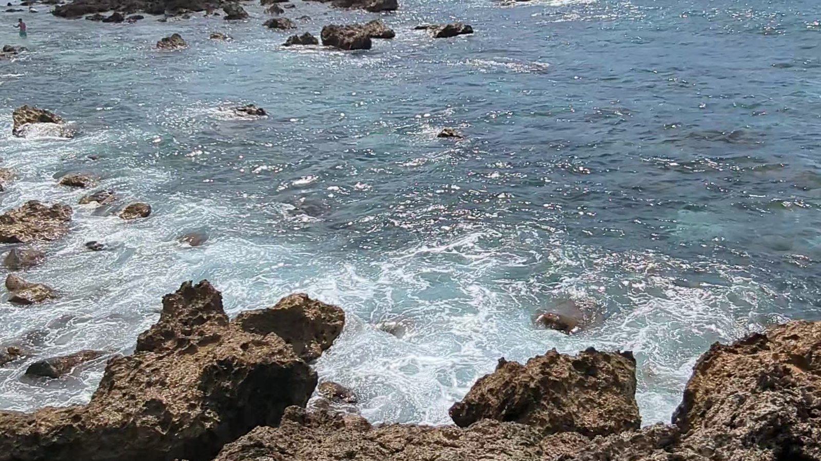 Surf washing over the lava rocks at Shark's Cove