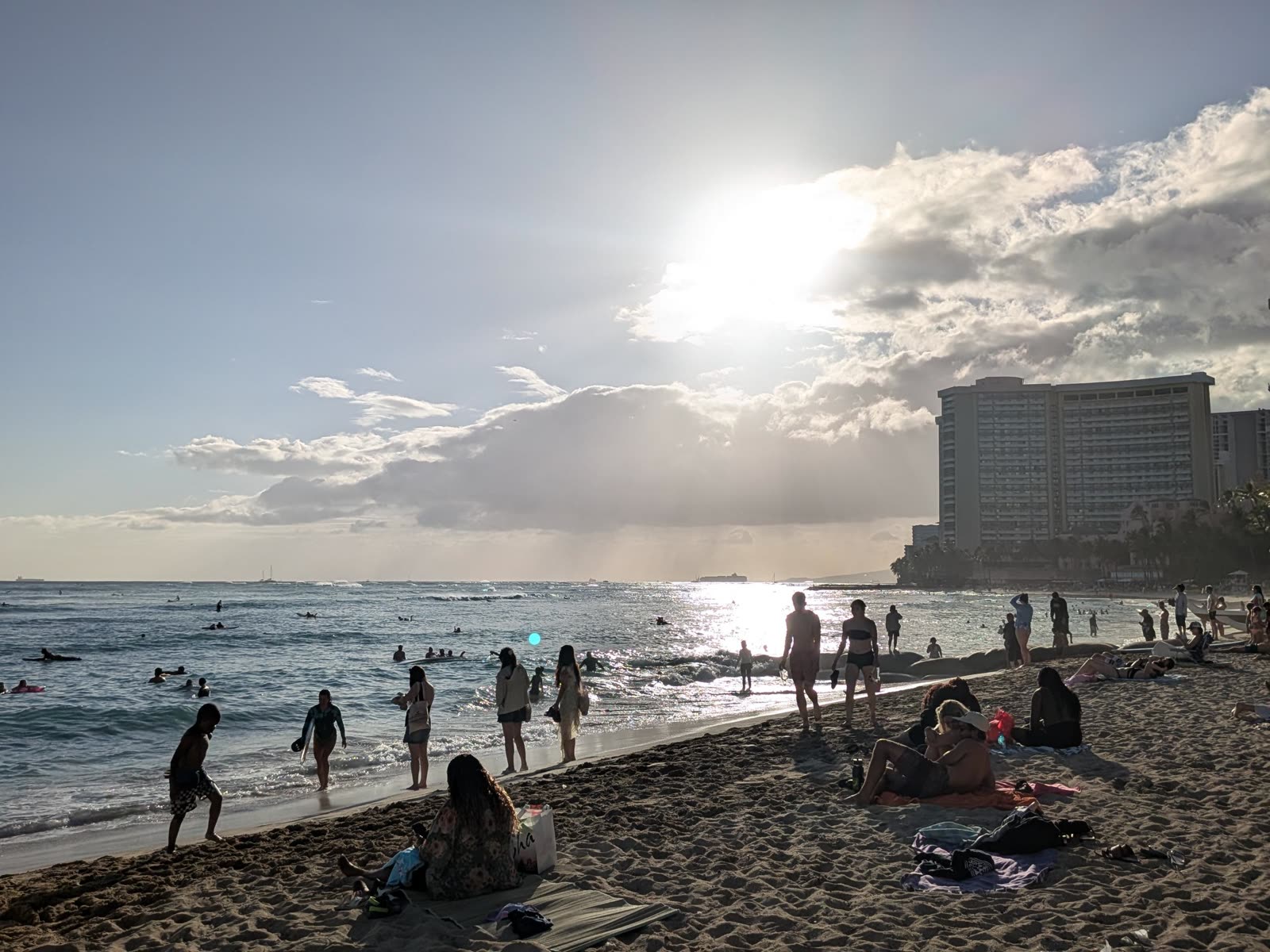 Surfers at Waikiki Beach at sunset