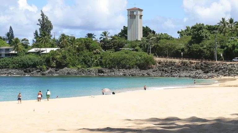 Waimea Bay on a calm day, with the church tower across the bay